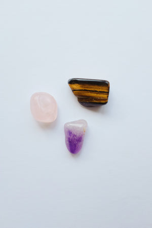 Packet of crystals for stress relief, containing a variety of calming stones to help alleviate anxiety and promote relaxation.